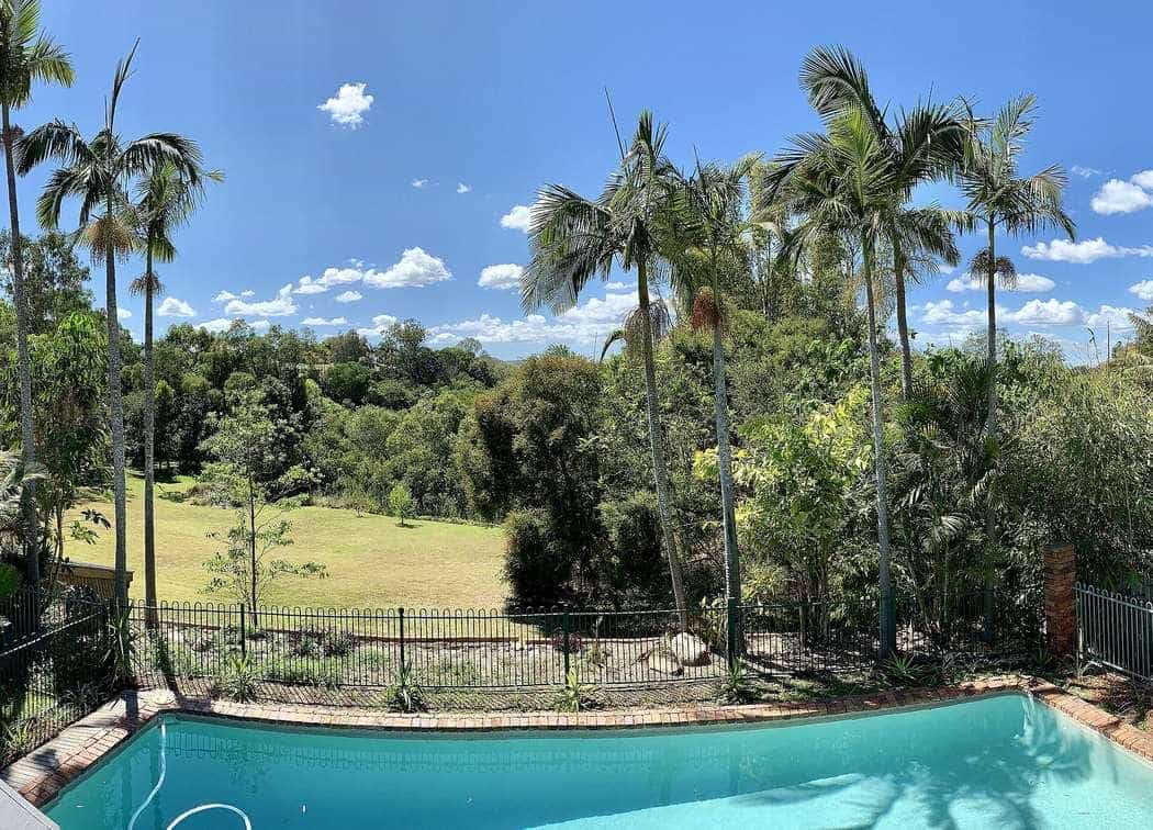 A backyard swimming pool behind a house in Corinda, Queensland