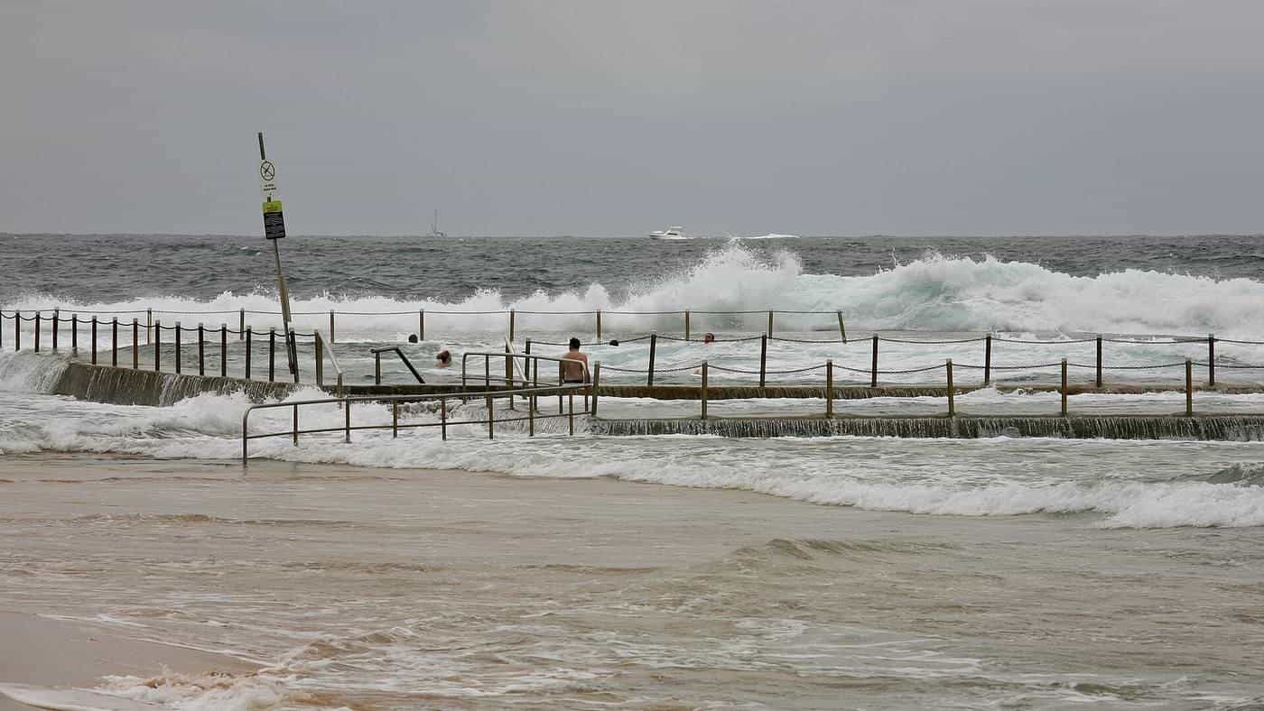 A rock pool and paved surrounds at Mona Vale Beach in Sydney